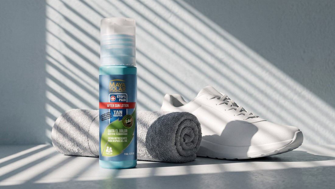 Crema After Sun de Maya Solar de 75 ml de pie sobre una superficie gris clara, junto a una toalla gris enrollada y un tenis blanco, bajo la luz rayada de una persiana